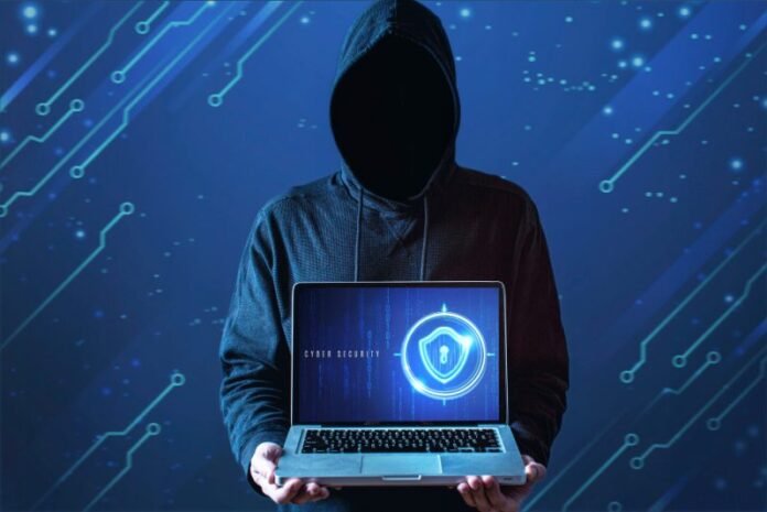 medium-shot-man-with-hoodie-holding-laptop-e1646646997479-1-696x465