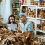 craftsman-gives-paper-craft-item-sketch-businesswoman-while-handicraft-workshop-1024x683