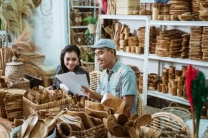 craftsman-gives-paper-craft-item-sketch-businesswoman-while-handicraft-workshop-1024x683